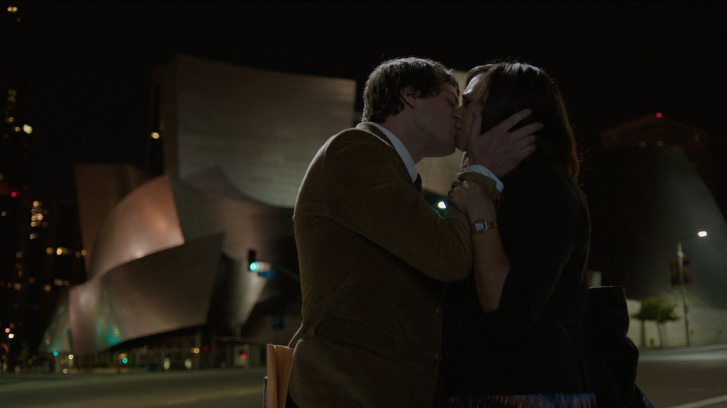 There is nothing more romantic than smooching in front of a giant fondant ribbon.